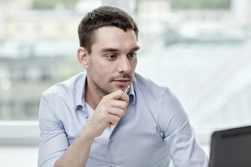 young businessman with laptop computer at office