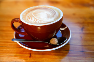 Brown cup of coffee on the table, latte art