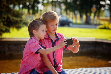 Best friends. Two cute little boys doing selfie  and making funn