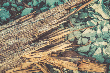 broken wood lumber with sharp spill in rock background.