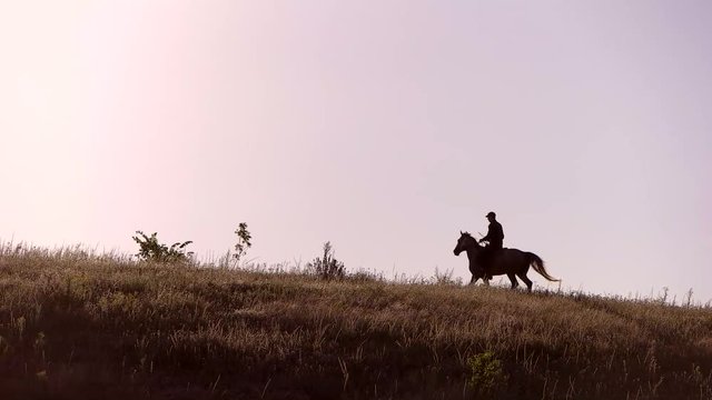 Horse rider moving in slo-mo. Horseman on sky background. All goals will be reached. Nothing can hold us back.