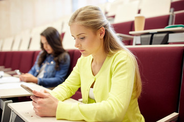 student girls with smartphones on lecture