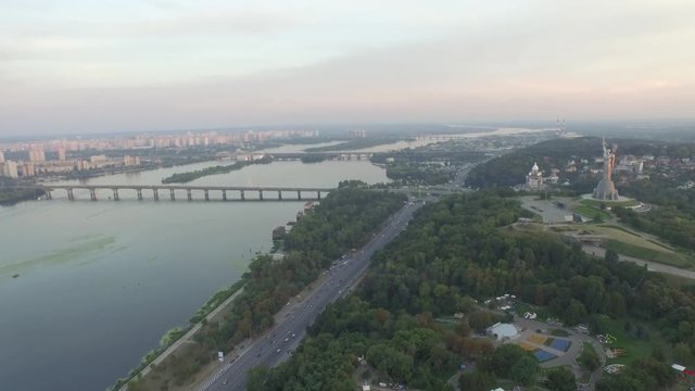 Panoramma of Kiev with the monument Motherland mother in the foreground. View of the left bank of the Dnieper River and the bridge Paton. Rodina-Mat. Aerial view 3840x2160 video 4k