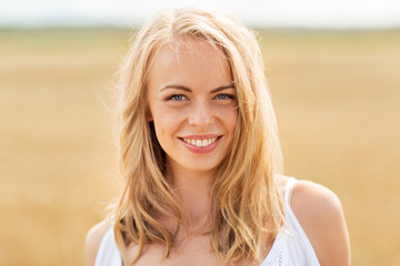 smiling young woman in white on cereal field