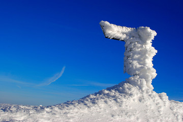 Wegweiser im Winter, vereist und schneebedeckt