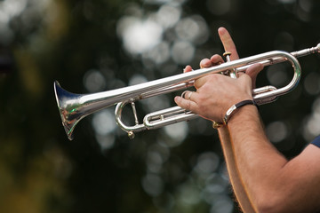  Hands of the musician playing a trumpet
