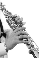 Obraz premium Saxophone in the hands of a musician of a closeup in black and white