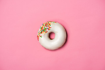 Donuts with icing on pastel pink background. Sweet donuts.