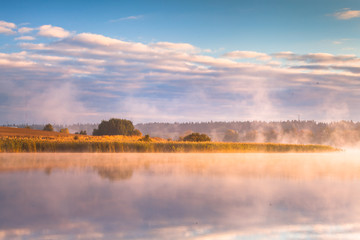 Fototapeta na wymiar misty morning on Mazury lake 