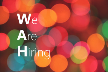 We Are Hiring text on colorful bokeh background