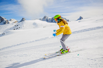 Fototapeta na wymiar Teenager ski rider on fresh powder snow on slope in Italy, San Martino di Castrozza, Dolomites