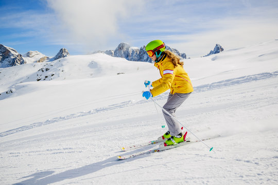 Teenager ski rider on fresh powder snow on slope in Italy, San Martino di Castrozza, Dolomites