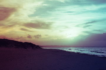 Fototapeta na wymiar Filtered vintage view of seaside at dusk in Sardinia