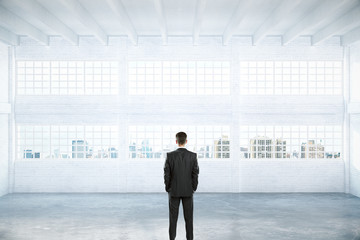 Obraz premium Man standing in empty hangar