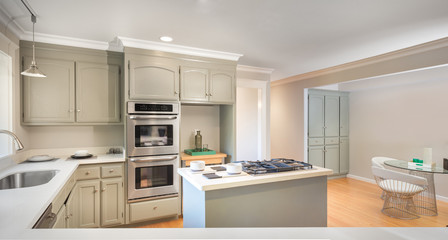 Interior of modern kitchen in white blue gray tones and new stai