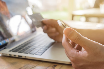 Fototapeta premium Online payment,Man's hands holding a credit card and using smart
