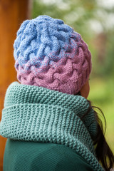 Beautiful brunette woman wearing knitted scarf and hat.