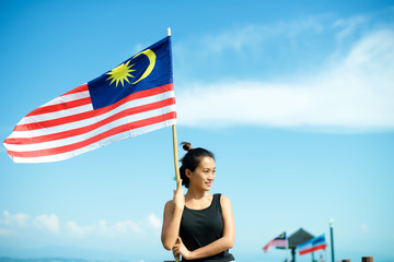 Girl on pier with Malaysian flag
