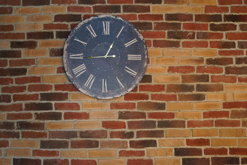 Fototapeta na wymiar Antique clock on a brick wall