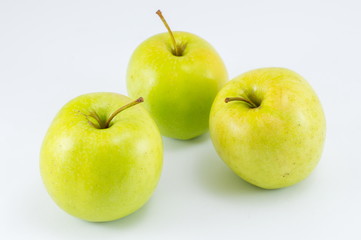 Three green apples on white