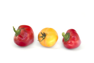 Two red peppers and one yellow tomato isolate