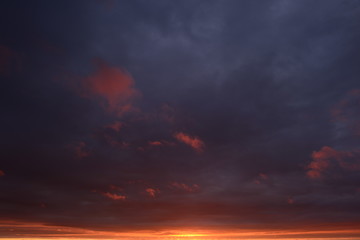 Gloomy dark blue sky in flames Sunset