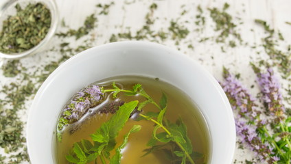 Mint tea with herbs in a teacup