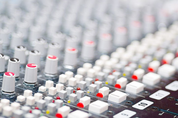 Fototapeta premium Closeup mixing faders and knobs as seen from above side angle, artistic studio equipment concept