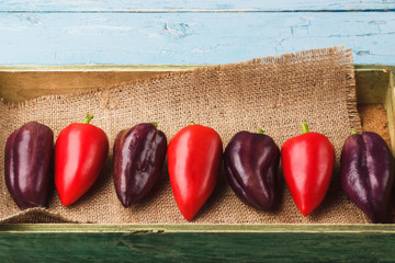 Colored peppers in the wooden tray