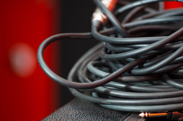 Closeup standard black audio cables rolled into bundle, studio equipment concept