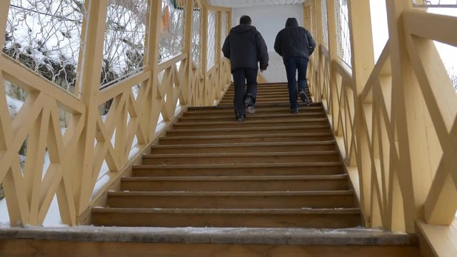Two Men go up the Stairs.