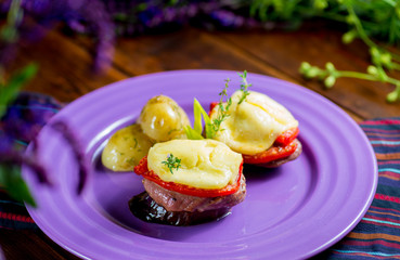 Canapes of eggplant, meat, cheese and tomatoes
