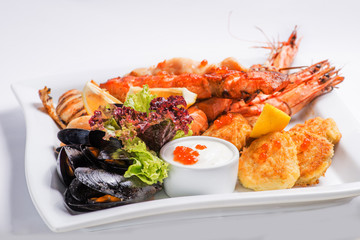 set of grilled  seafood grilled on a white plate. Serving for the restaurant menu