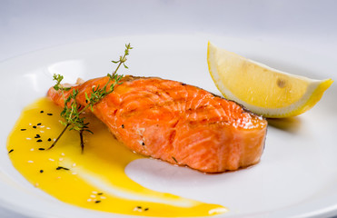 piece of grilled salmon served with vegetables