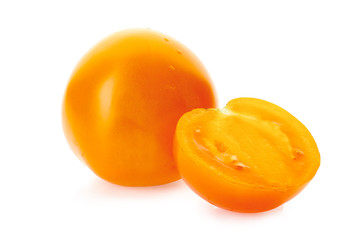 Yellow tomatoe with half slice on white