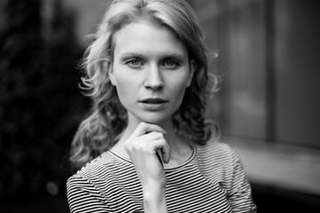 Black and white portrait of curly girl looking at camera