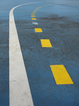 The yellow line on blue floor