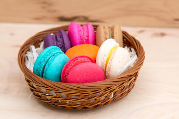 Colorful  macaroons in stack on light wooden background