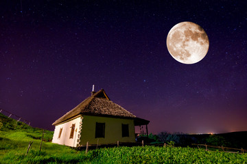 traditional ukrainian house in old village under night sky