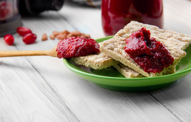 cornel jam on gallet and wooden spoon with jam. selective focus