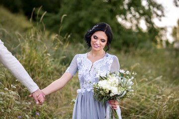 Young couple in love outdoor. Elegant bride and groom posing together outdoors on a wedding day....