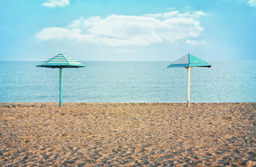  Two parasol on the empty beach. Vintage toning.
