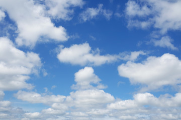 White clouds flying against clear blue sky.