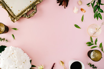 creative decorated and arranged flat lay frame concept with vintage tray, hydrangea, shells, coffee, golden spoon, branches on pink background. top view