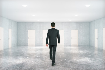 Fototapeta premium Man walking in room with doors