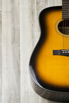 Acoustic guitar on wooden background