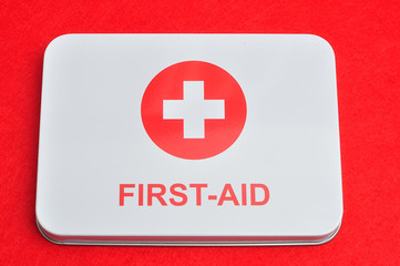 First aid sign isolated against a red background