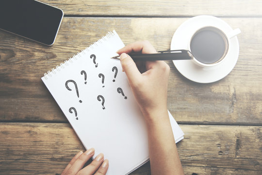 question mark on notebook - Powered by Adobe