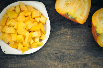 Autumn raw sliced pumpkin on rustic wooden background
