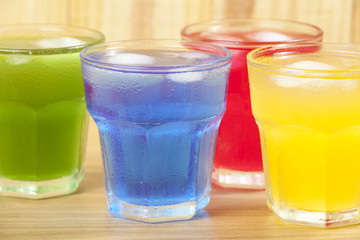 Above shot of four glasses with different flavor drinks
